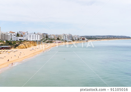 Armacao de Pera Algarve Portugal. Beautiful view on Atlantic ocean at day time and city Armacao de Pera Algarve Portugal. Beautiful view on Atlantic ocean at day time and city 91105016