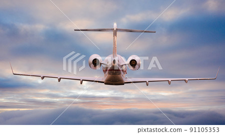 Private airplane jetliner flying above dramatic clouds in beautiful sunset light. Travel concept. 91105353
