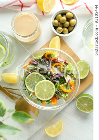 Concept of tasty food with vegetable salad with tahini sauce on white wooden background Concept of tasty food with vegetable salad with tahini sauce on white wooden background 91105444