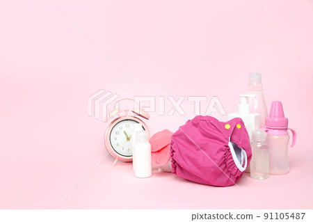 Concept of baby clothes with reusable diapers on pink background 91105487