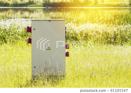 Electric high voltage distribution cabinet at the lake shore Electric high voltage distribution cabinet at the lake shore 91105547