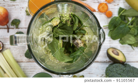 Fresh fruit and vegetables smoothie blended in blender, top view. Healthy eating concept. 91105567