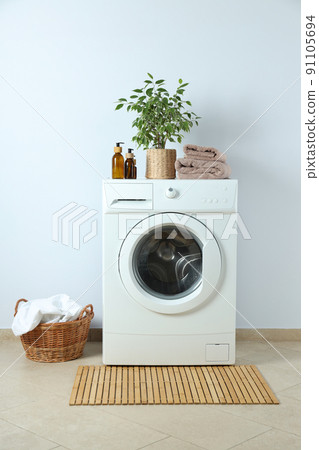 Concept of housework with washing machine against white wall Concept of housework with washing machine against white wall 91105694