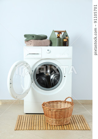 Concept of housework with washing machine against white wall 91105701