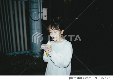 Girl taking a walk at night 91107672