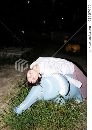 Girl taking a walk at night 91107692