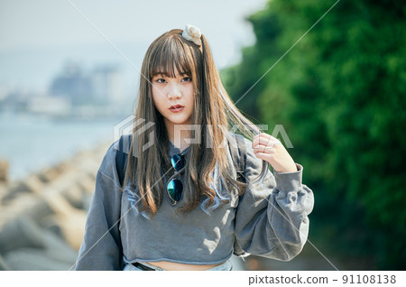 Gen Z women standing looking at the camera Gen Z women standing looking at the camera 91108138