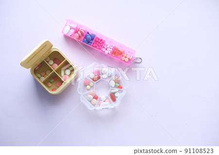 top view of medical pills in a pill box on white background top view of medical pills in a pill box on white background 91108523