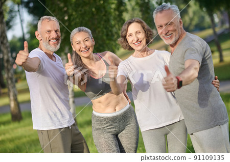 Group of people spending time together in the park and looking happy 91109135