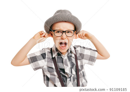 Portrait of cute little boy, happy kid in eyeglasses and hat isolated on white studio background with copyspace for ad. Retro vintage style concept 91109185
