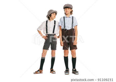 Cheerful little boys, stylish kids wearing retro clothes posing isolated over white background. Concept of childhood, vintage summer fashion style Cheerful little boys, stylish kids wearing retro clothes posing isolated over white background. Concept of childhood, vintage summer fashion style 91109231