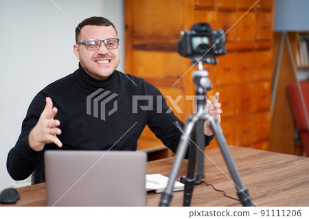 man filming video blog on camera with tripod for online followers. In social media, Influencer, new technology and internet concept 91111206