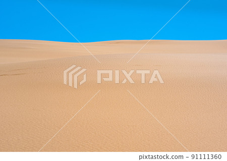 lifeless sandy desert landscape under blue sky 91111360
