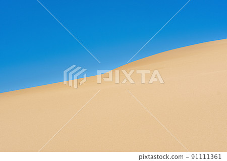 desert landscape, slope of a high sand dune against a blue sky desert landscape, slope of a high sand dune against a blue sky 91111361