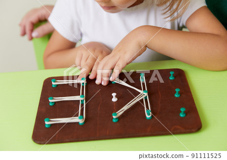Woman teaches child the alphabet. Development of fine motor skills concept Woman teaches child the alphabet. Development of fine motor skills concept 91111525