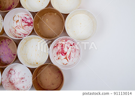 Dirty used disposable bowls on a light background. 91113014