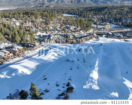 Aerial view of mountain ski resort with beautiful winter landscape 91113335