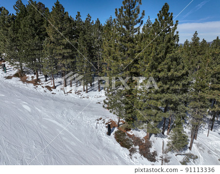 Aerial view of mountain ski resort with beautiful winter landscape 91113336