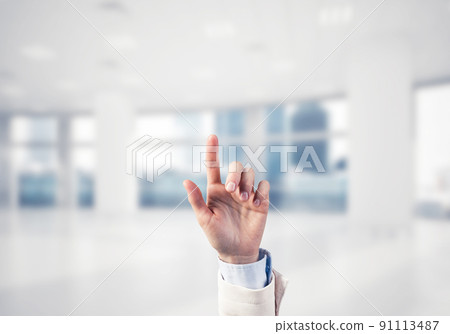 Choosing gesture of businessperson in elegant modern interior in sunshine light 91113487