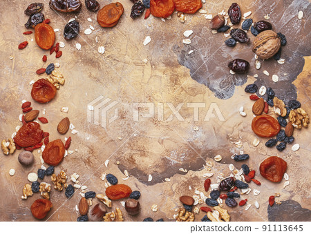 Healthy food dried fruits. prunes, dried apricots, raisins, figs, nuts. Top view. Copy space. Healthy food dried fruits. prunes, dried apricots, raisins, figs, nuts. Top view. Copy space. 91113645