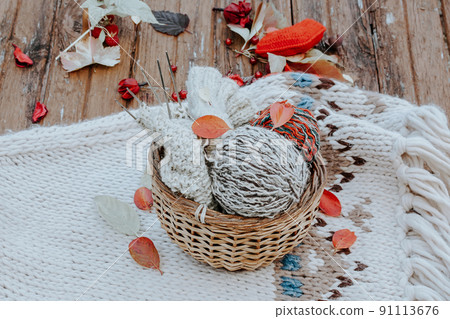 Autumn knitting of warm clothes. Woolen balls of knitting needles. Self-made things with love. Idea for handmade gifts 91113676
