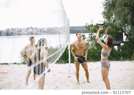 Sports and active life theme. Young players play volleyball. Beach playground. Sports and active life theme. Young players play volleyball. Beach playground. 91113707