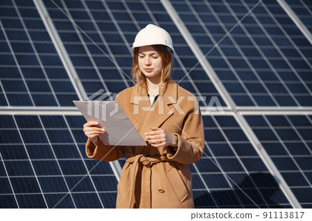 Businesswomen working on checking equipment at solar power plant. With tablet checklist, woman working on outdoor at solar power. 91113817