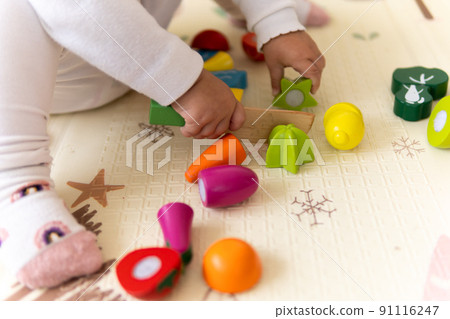happy funny kid curly baby girl with educational toy blocks flowers. Children play at day care or preschool. Mess in kids room. Toddler build tower in kindergarten. Child playing with colorful toys happy funny kid curly baby girl with educational toy blocks flowers. Children play at day care or preschool. Mess in kids room. Toddler build tower in kindergarten. Child playing with colorful toys 91116247
