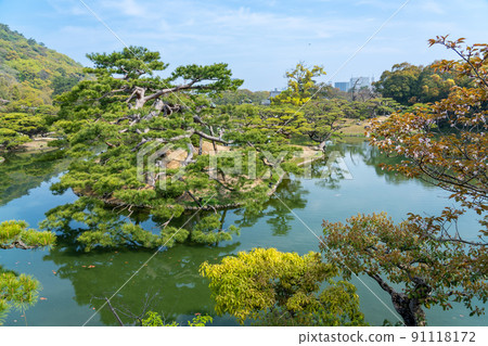 A splendidly maintained pine and pond in Ritsurin Garden, Takamatsu City, Kagawa Prefecture 91118172