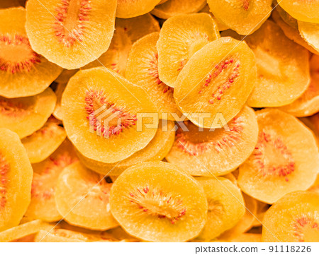 Yellow dried thin slices of kiwi in sugar full screen Yellow dried thin slices of kiwi in sugar full screen 91118226