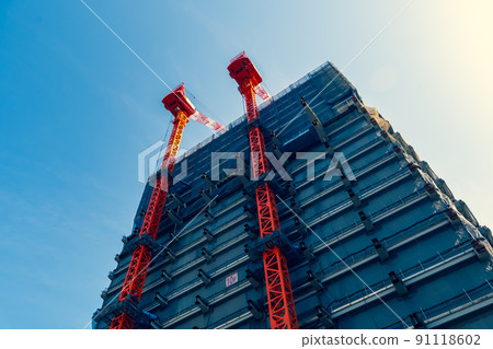 Skyscrapers and cranes under construction and clear sky b-4 Warm and cool colors emphasized Skyscrapers and cranes under construction and clear sky b-4 Warm and cool colors emphasized 91118602
