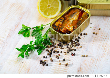 Tin can with smoked sprats, sardines, closeup Tin can with smoked sprats, sardines, closeup 91119733