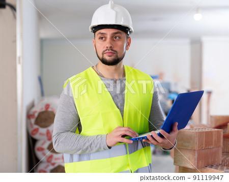 Foreman with laptop on indoor construction site Foreman with laptop on indoor construction site 91119947