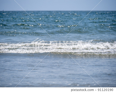 The calm waves that hit the sandy beaches of the summer sea. 91120190