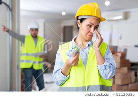 Woman engineer crying, disappointed by low salary 91120386