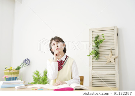 High school girl thinking while studying at home High school girl thinking while studying at home 91122297