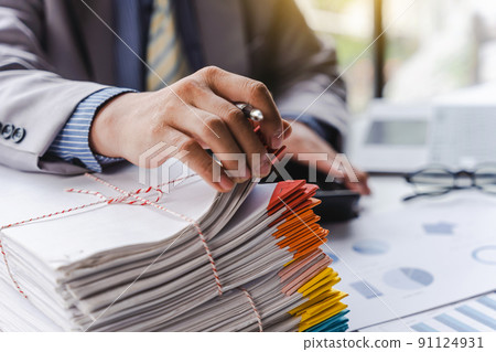 Stack of documents, pile of papers on office desk employee's table, closeup, Asian people. 91124931