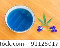 Cannabis ,Marijuana and  Blue Pea, herb hot tea on the bowl with  Cannabis leaf and  Blue Pea flower. 91125017