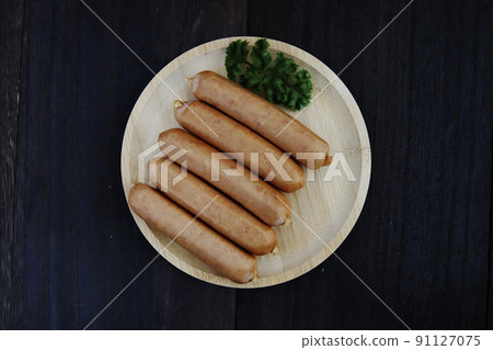 Frankfurt-like sausage with traditional German pork stuffed with parsley on the table Frankfurt-like sausage with traditional German pork stuffed with parsley on the table 91127075