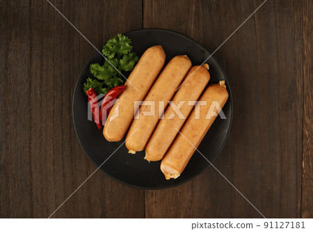 Frankfurt-like sausage with traditional German pork stuffed with parsley on the table Frankfurt-like sausage with traditional German pork stuffed with parsley on the table 91127181