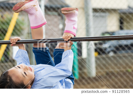 Girl working hard on the horizontal bar Girl working hard on the horizontal bar 91128565