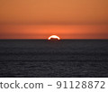 Sunset over the Atlantic Ocean and a cargo ship 2 91128872