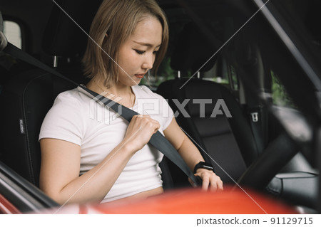 A woman with a seat belt A woman with a seat belt 91129715
