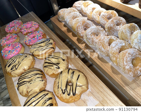 Close up Group of delicious donuts on bakery shop, tasty multiple donuts 91130794