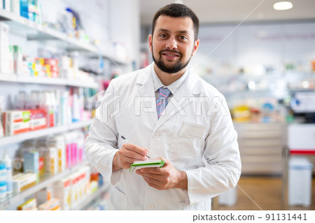 Portrait of male pharmacist working in drugstore 91131441
