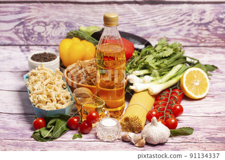 Italian pasta with vegetables, olive oil, spices on a wooden background 91134337