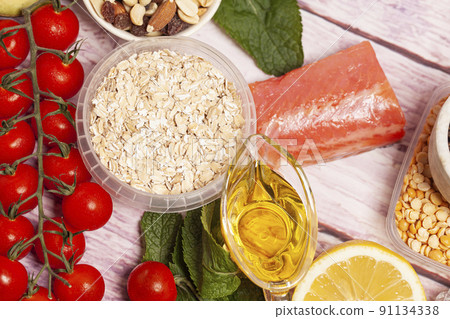 Balanced diet food background. Organic food for healthy nutrition, vegetables,hercules,olive oil,fish,herbs,nuts,dried fruits, seeds and greens 91134338