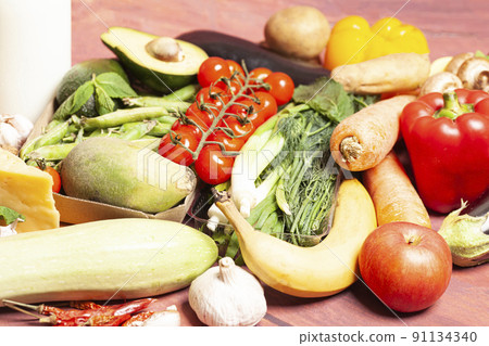 Healthy food selection with fruits,vegetables,cheese,nuts, milk,spices, on wooden background 91134340