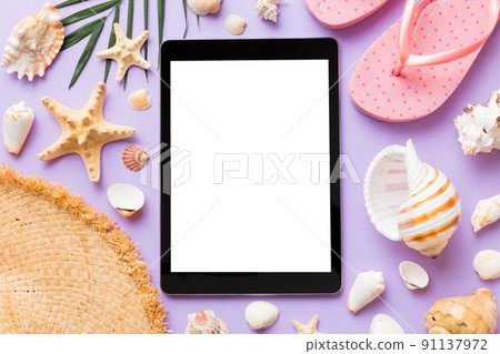 Flat lay composition with tablet and beach accessories on colored background. Tablet computer with blank screen mock up with copy space Flat lay composition with tablet and beach accessories on colored background. Tablet computer with blank screen mock up with copy space 91137972
