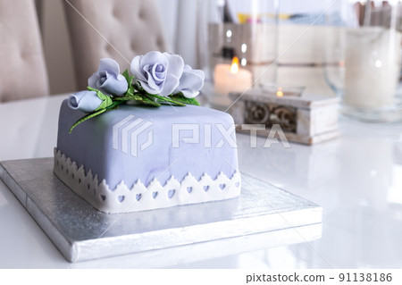 Beautiful decorated fruit cake with blue roses Beautiful decorated fruit cake with blue roses 91138186